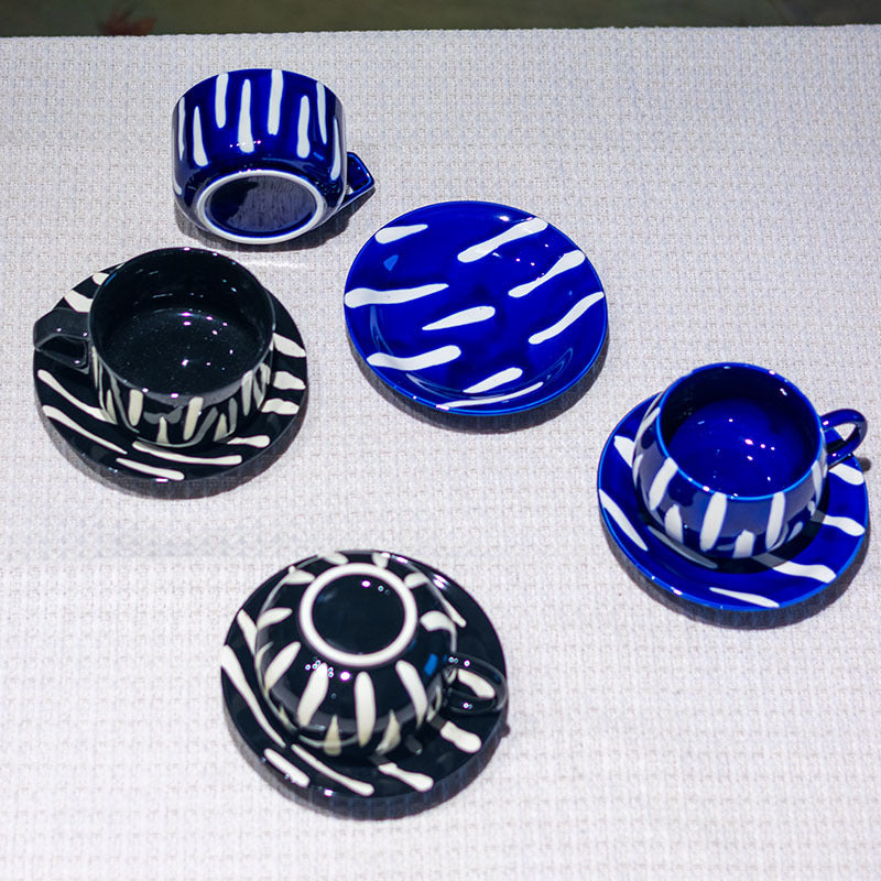 Glazed interiors and saucer patterns of striped ceramic coffee cups