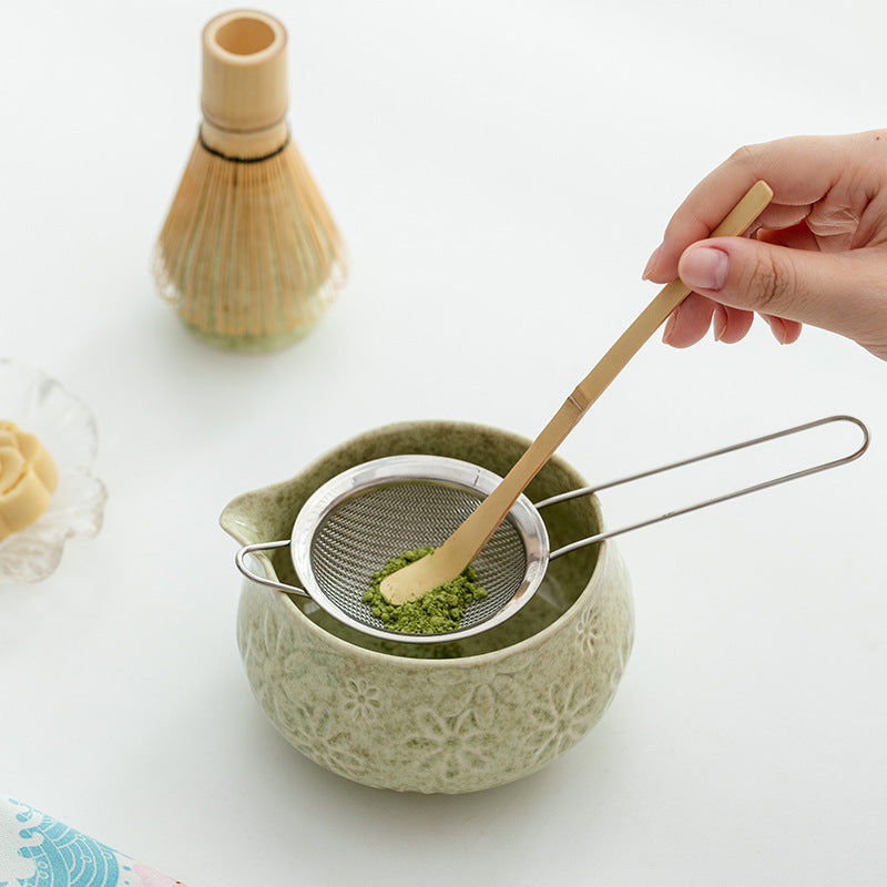 Preparing matcha in the floral relief bowl; whisk, scoop, sieve and ingredients are styling props and are not included