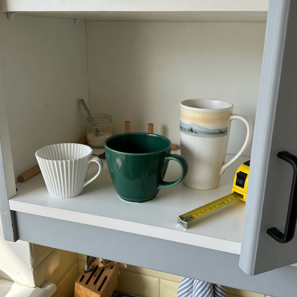 Americano coffee cup storage fit guide with Pleated 200 ml, Emerald 270 ml, and Landscape Tall 350 ml cups on a cabinet shelf