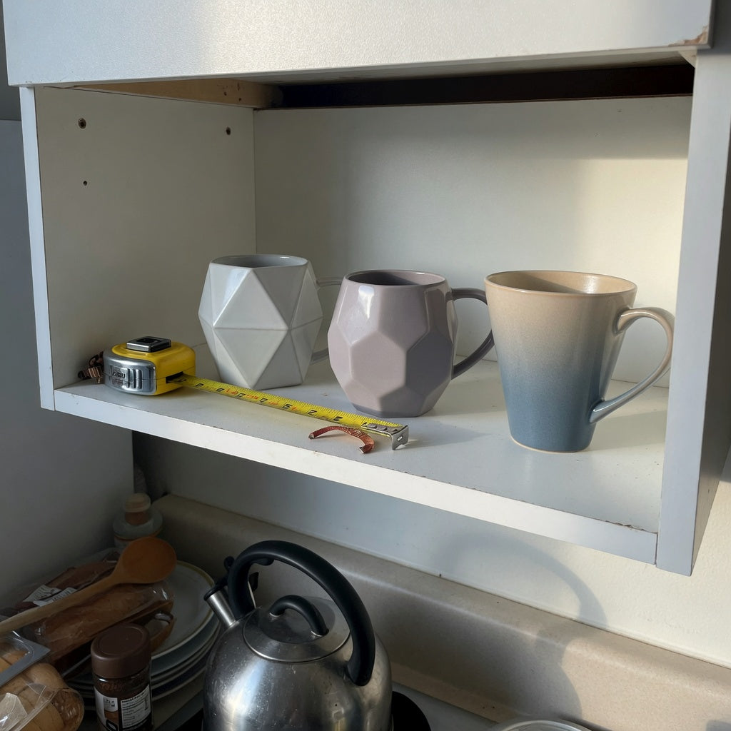 Geometric coffee mug compact kitchen product shortlist guide comparing three ceramic mug shapes on a shallow cabinet shelf