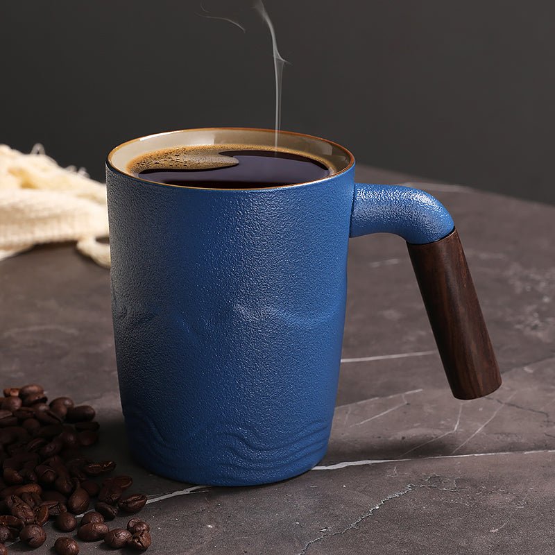 clay pottery coffee mugs for desk use beside a keyboard, coaster, notebook, and measuring tape