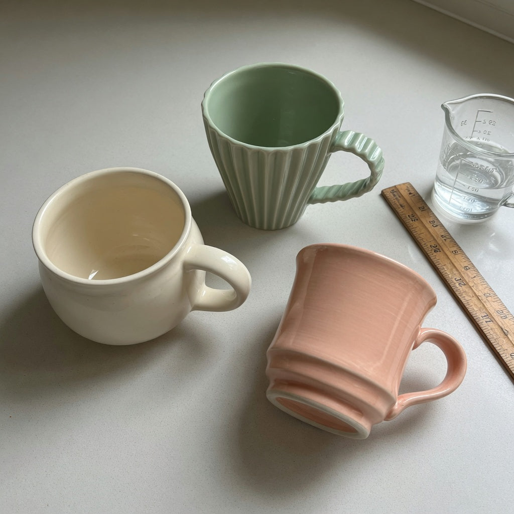 minimalist ceramic mug first time buyer practical purchase checklist with round, pleated, and retro ceramic forms on a kitchen counter