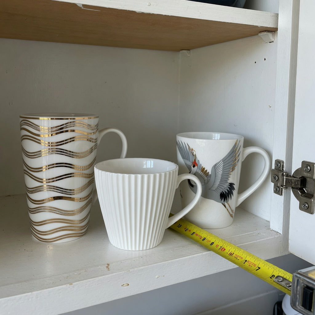 Cabinet scene for a plain white ceramic coffee mugs storage fit guide with tall, pleated, and crane designs