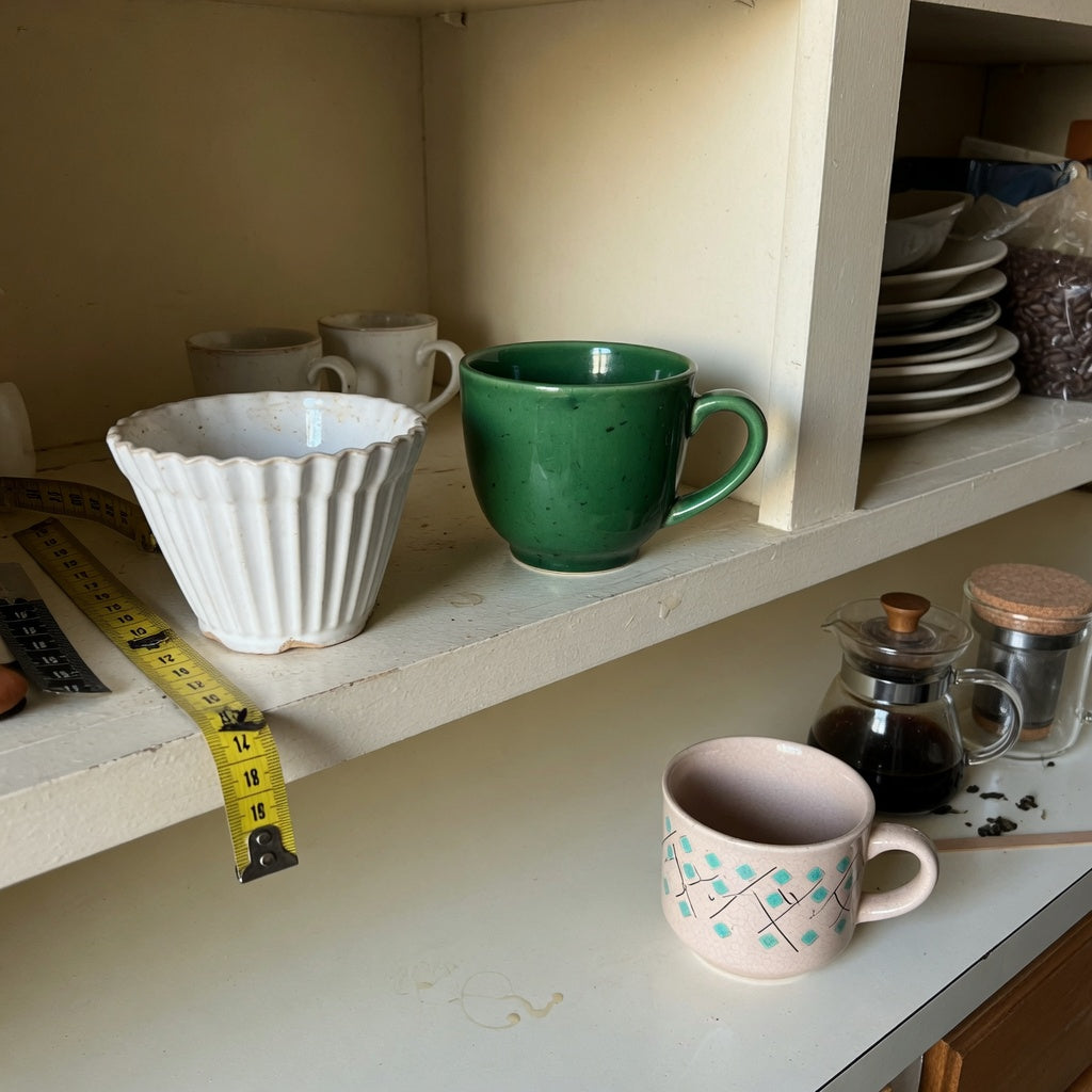 small ceramic coffee cup everyday mug rotation practical purchase checklist shown with three cups on a measured kitchen shelf