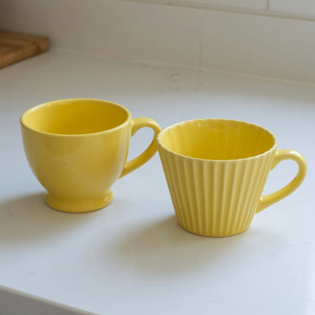 Yellow ceramic coffee mug current product facts comparison showing the Retro 170 ml and Pleated 200 ml yellow cups
