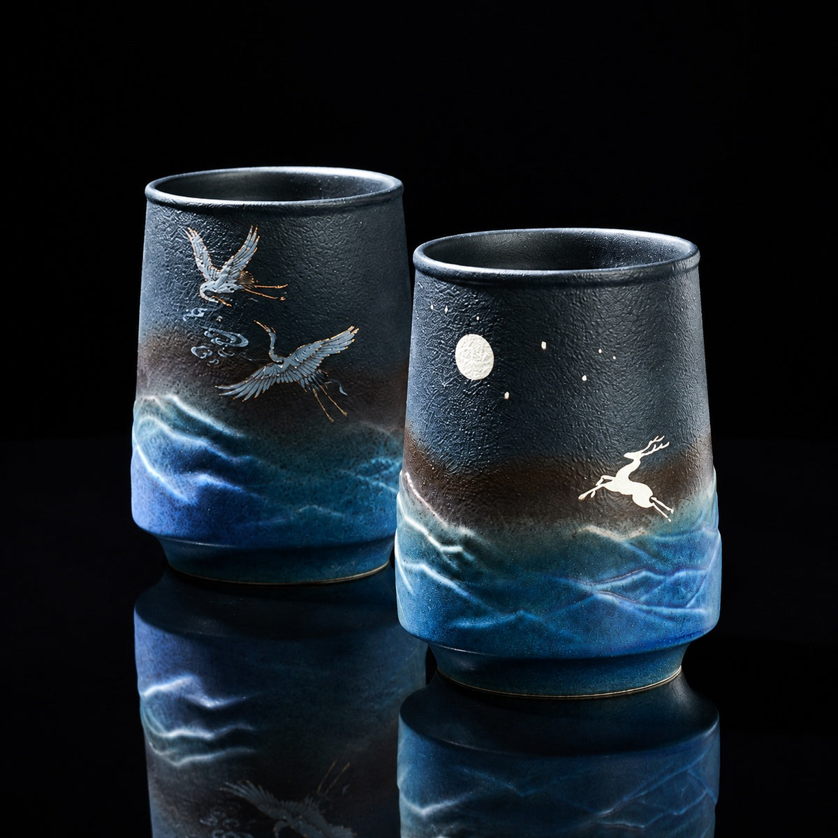 Deep blue stoneware tea and coffee mug set with crane and moon artwork