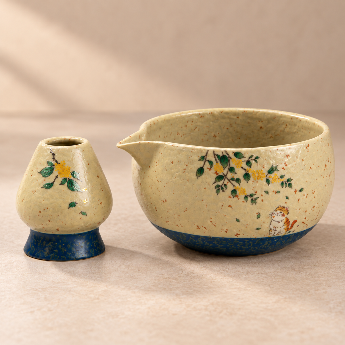 Close-up of the cat and blossom bowl and matching holder, showing the pouring spout, ceramic texture and interior
