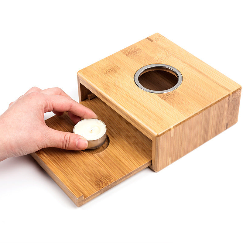 Hand placing a tea light on the sliding bamboo tray