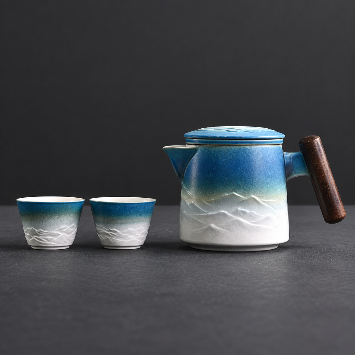 Blue and white mountain relief ceramic travel teapot with two matching cups