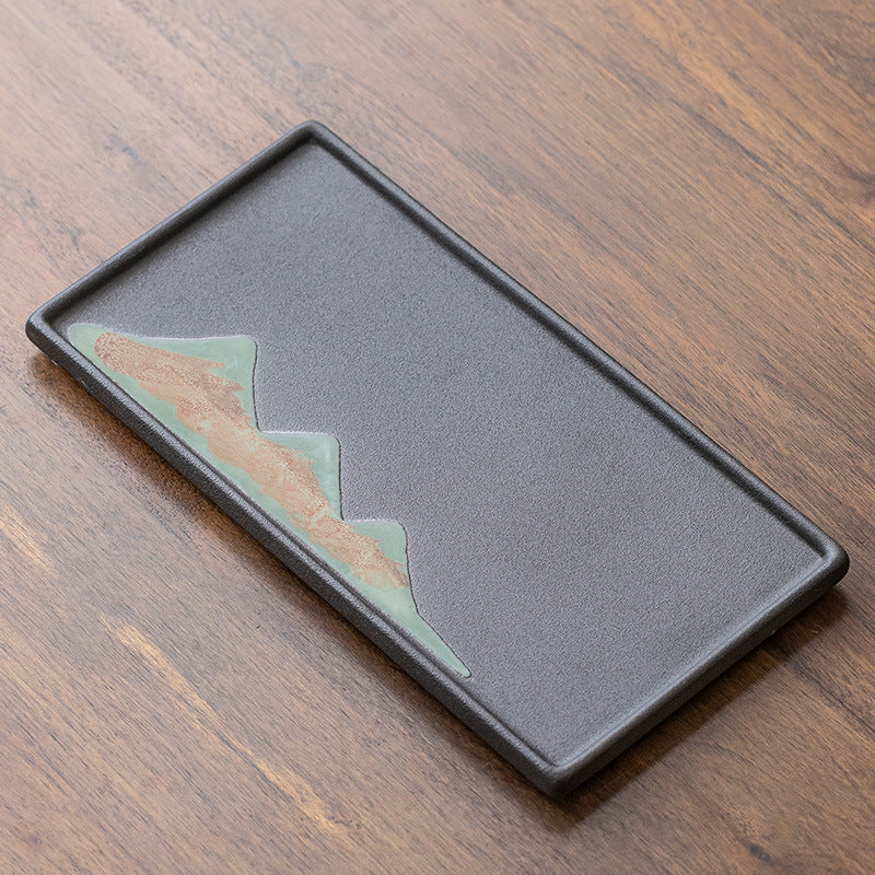 Black rectangular ceramic tea tray with a mountain motif
