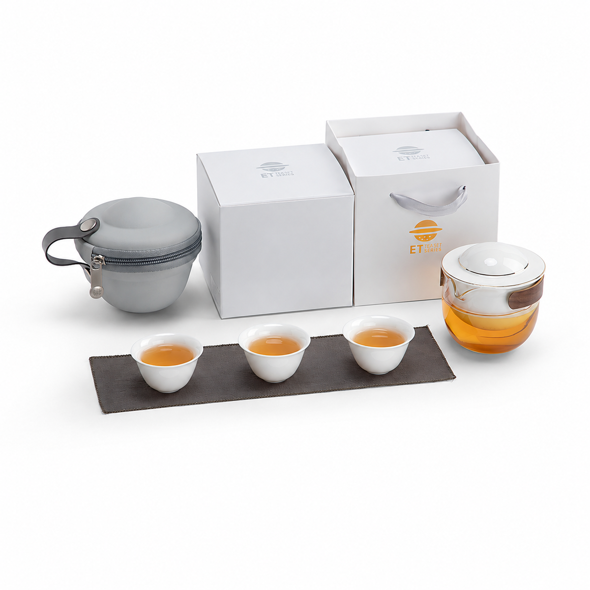 White glass travel tea set with pivoting ceramic infuser, three cups and gray carrying case