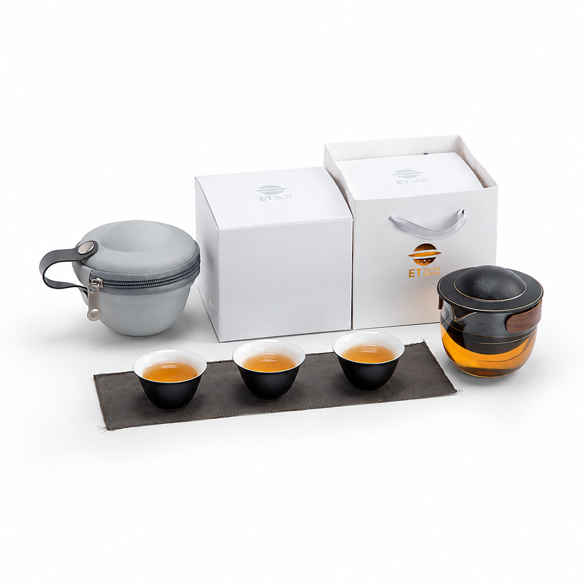 Black glass travel tea set with pivoting ceramic infuser, three cups and gray carrying case