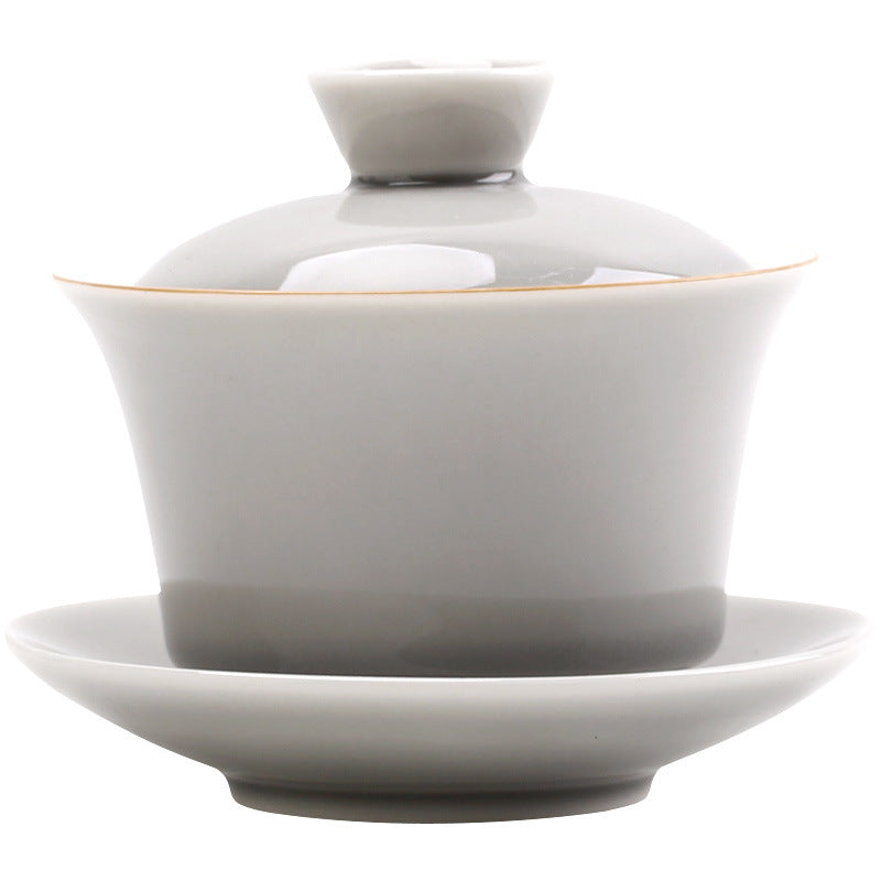 Grey tapered ceramic gaiwan with lid and saucer on white