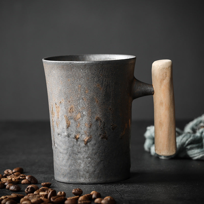 Tall Tapered Cup in dark textured ceramic with a warm metallic glaze and wooden handle