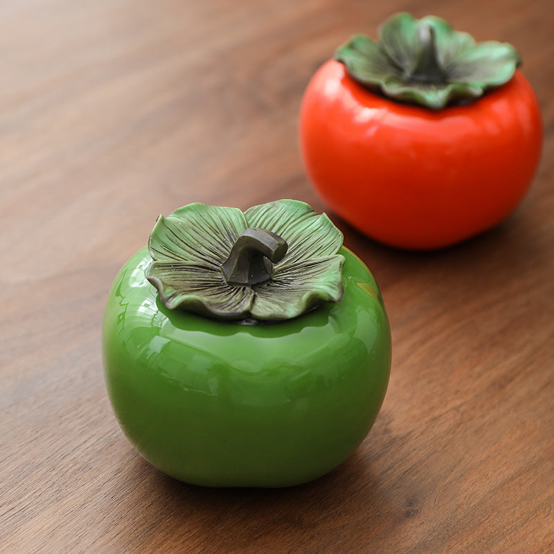 Green and orange persimmon-shaped ceramic canisters