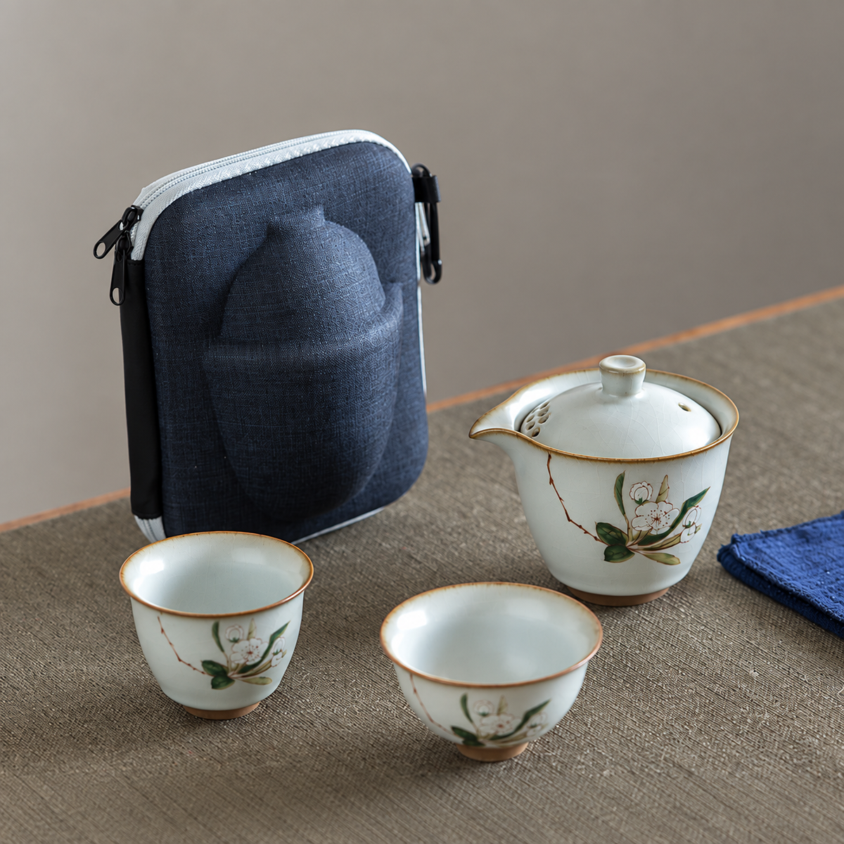 Camellia ceramic travel tea set with two cups and blue zip case