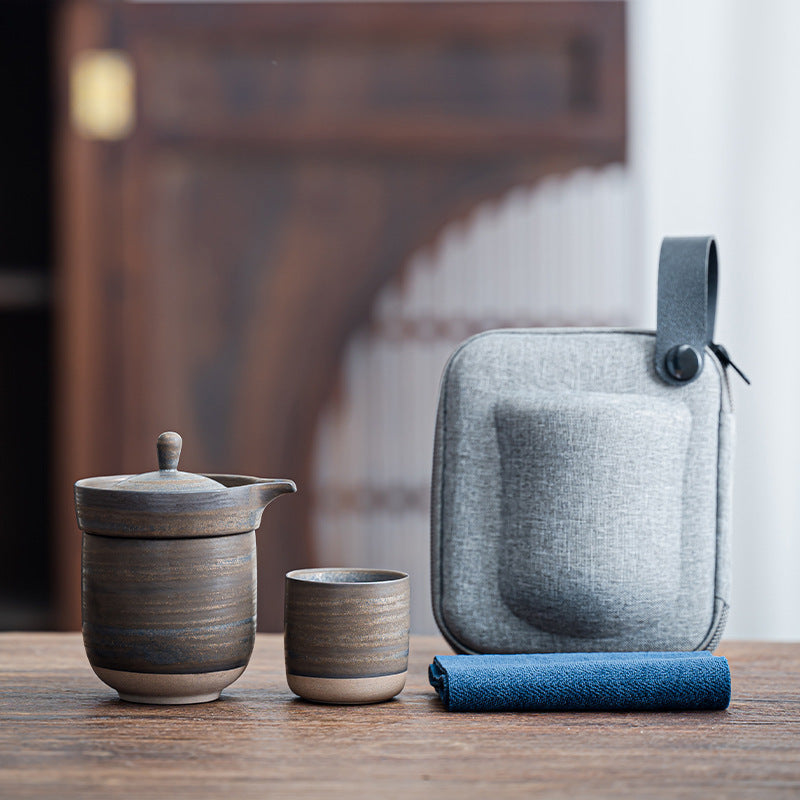 Dark bronze glaze ceramic travel tea set with a nesting cup and gray carry case