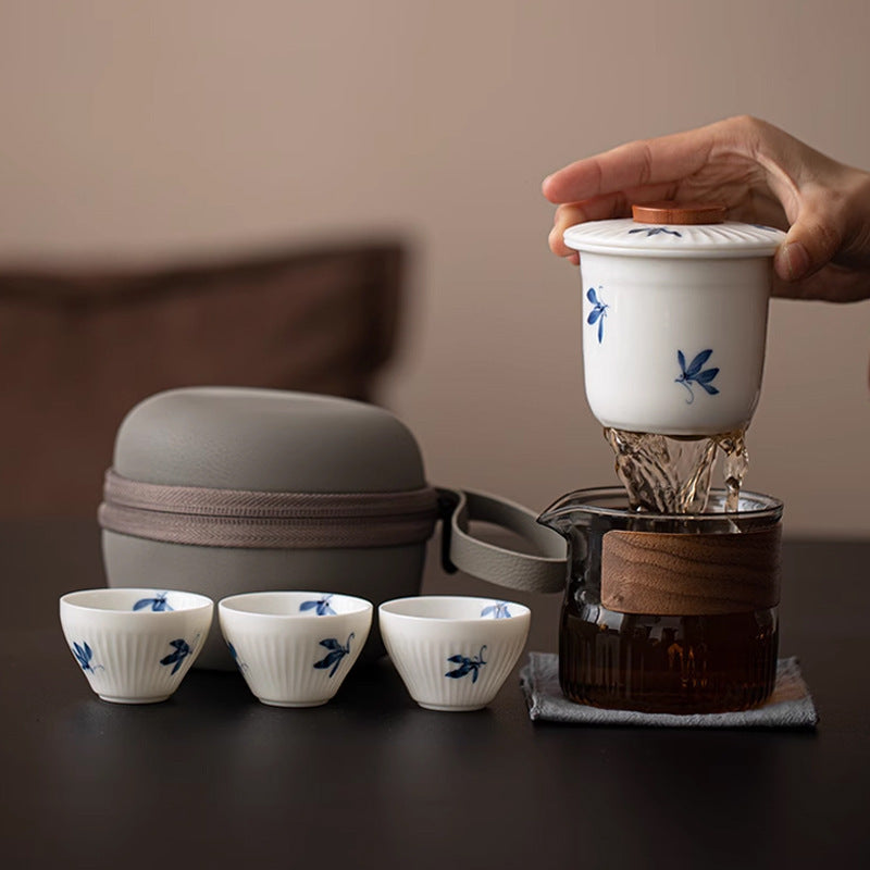 Blue floral travel tea set with glass pitcher, ceramic infuser, three cups and carry case