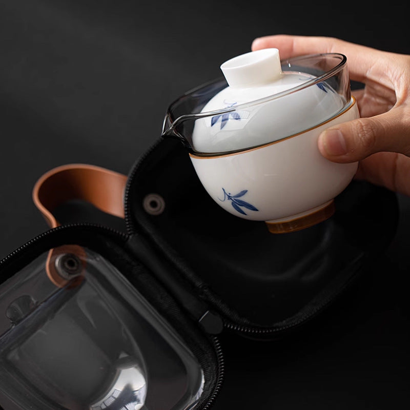 Glass pot and blue orchid ceramic cup nested together above a carrying case