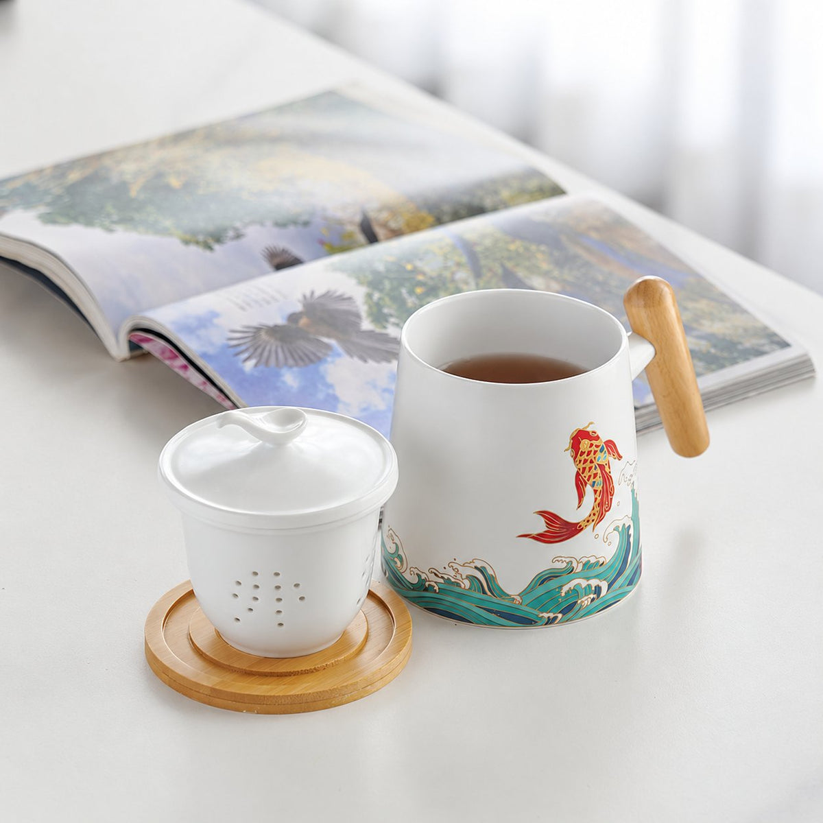 Koi patterned mug with removable infuser and bird-knob lid
