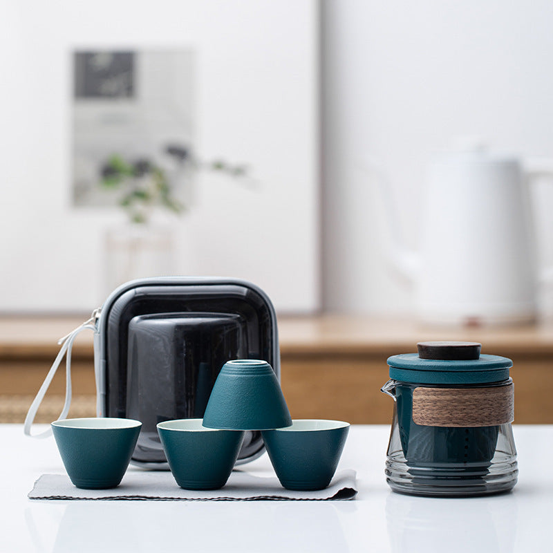 Green ceramic travel tea set with smoke-gray glass brewer, four cups and zip case