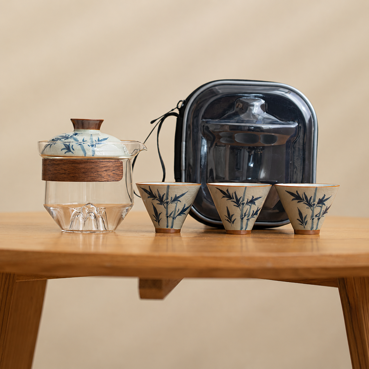 Bamboo / Clear glass tea brewer with three patterned ceramic cups and a black travel case