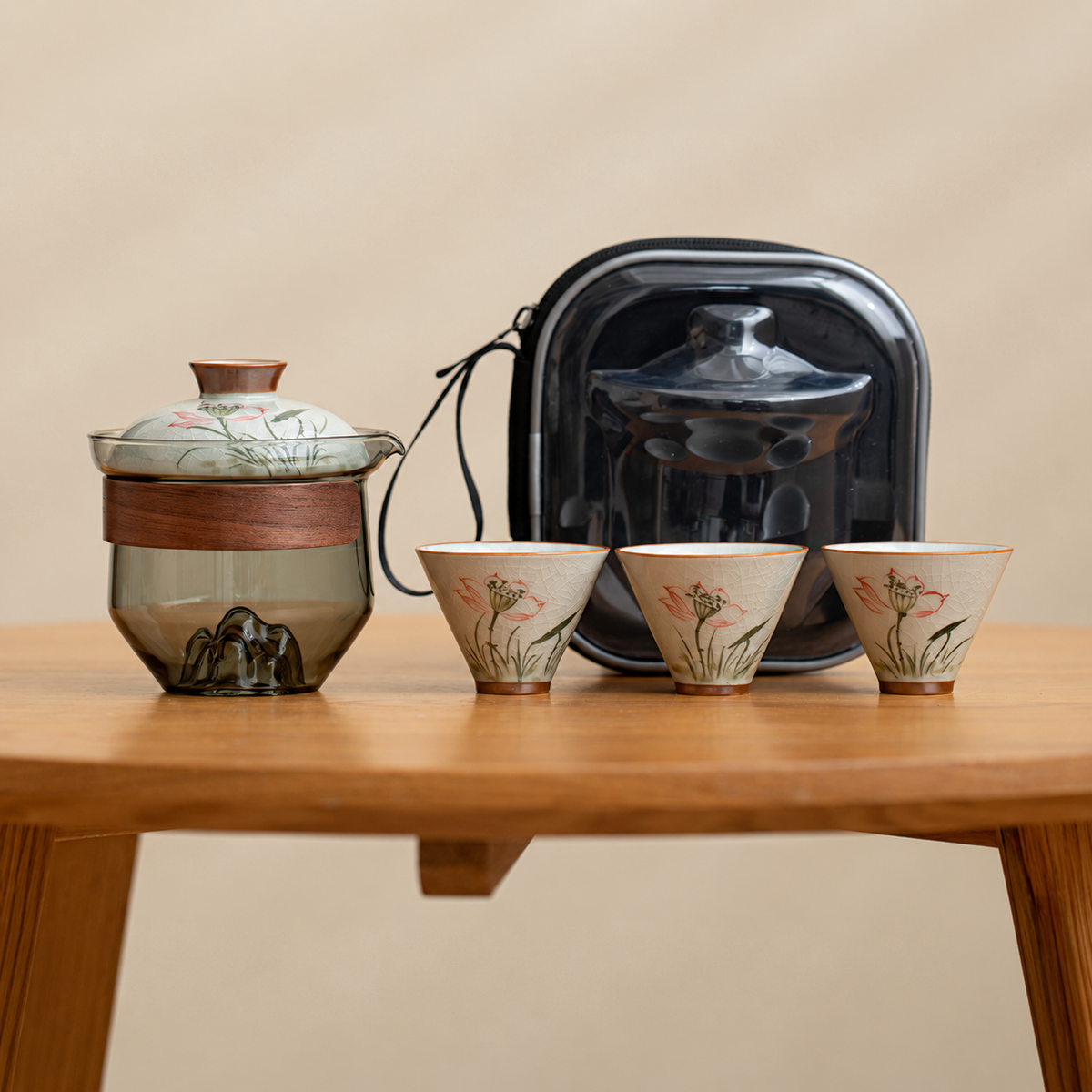Lotus / Smoke glass tea brewer with three patterned ceramic cups and a black travel case