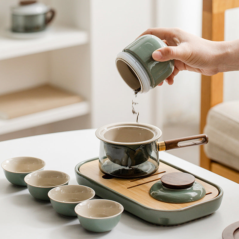 Loose leaf tea added from the canister to the ceramic infuser in a glass pot