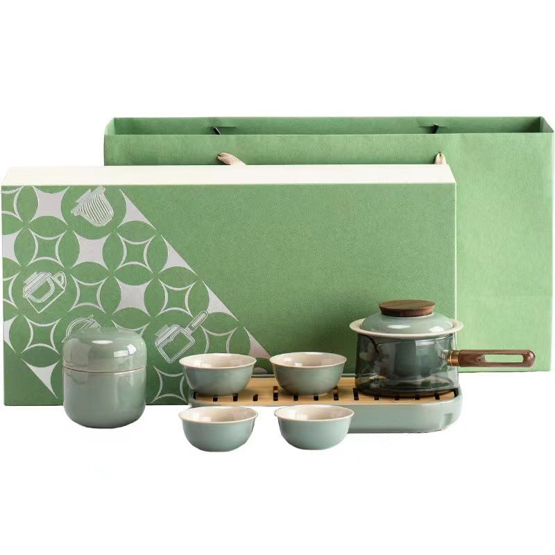 Green tea set with side-handle glass pot, four ceramic cups, canister and tray