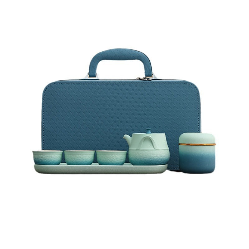 Blue-gradient ceramic travel tea set with three cups, tray, jar and teal carrying case