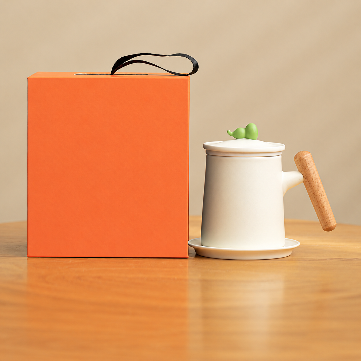 Cream gourd-knob ceramic infuser mug with wood grip, saucer and orange gift box