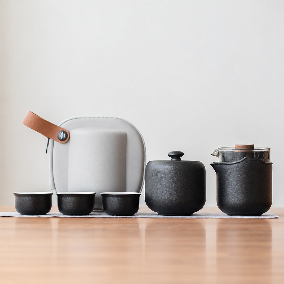 Black nested glass and ceramic travel tea set, tea jar configuration, with three cups and gray case