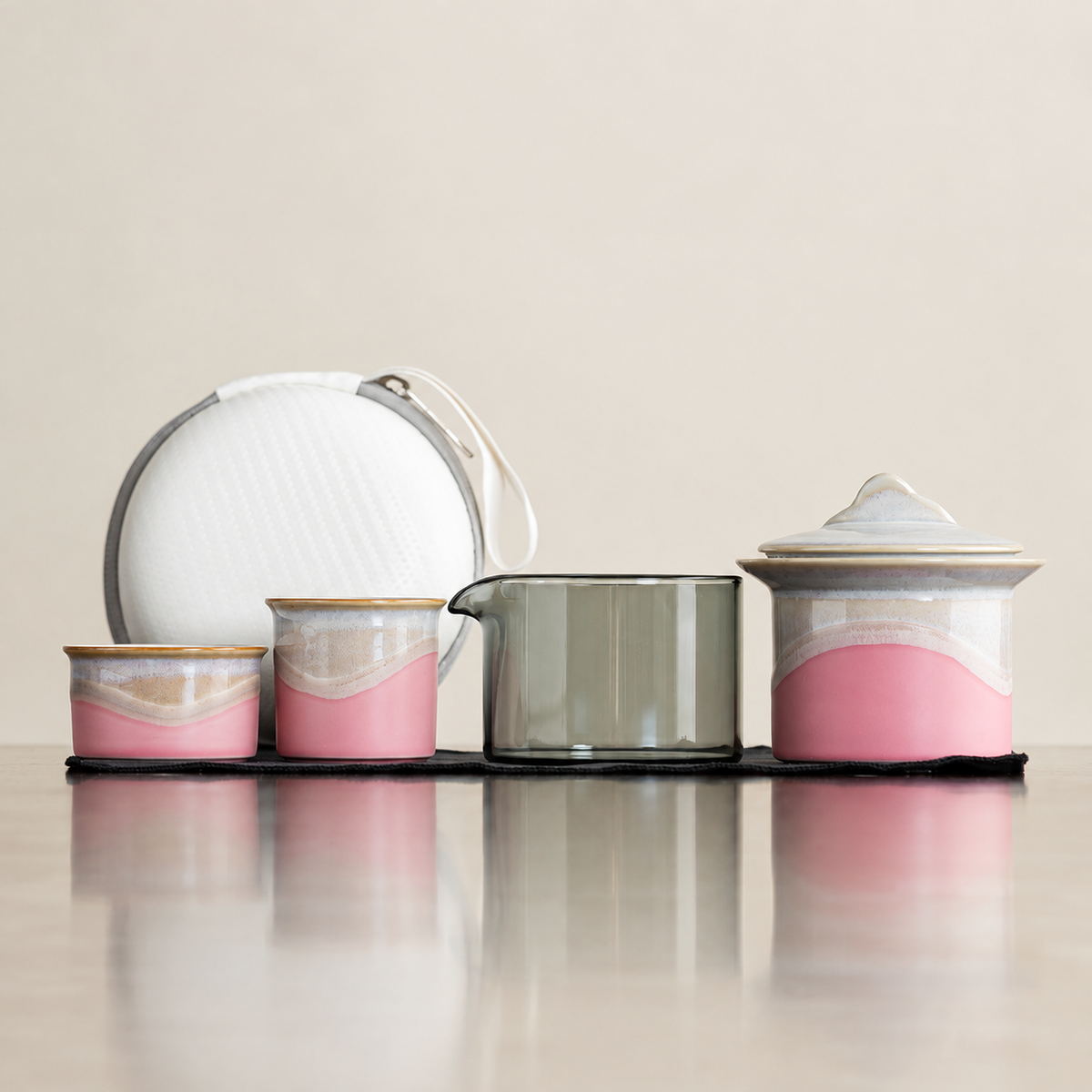 Pink landscape-glaze travel tea set with two cups, glass pitcher, lidded brewer and white case