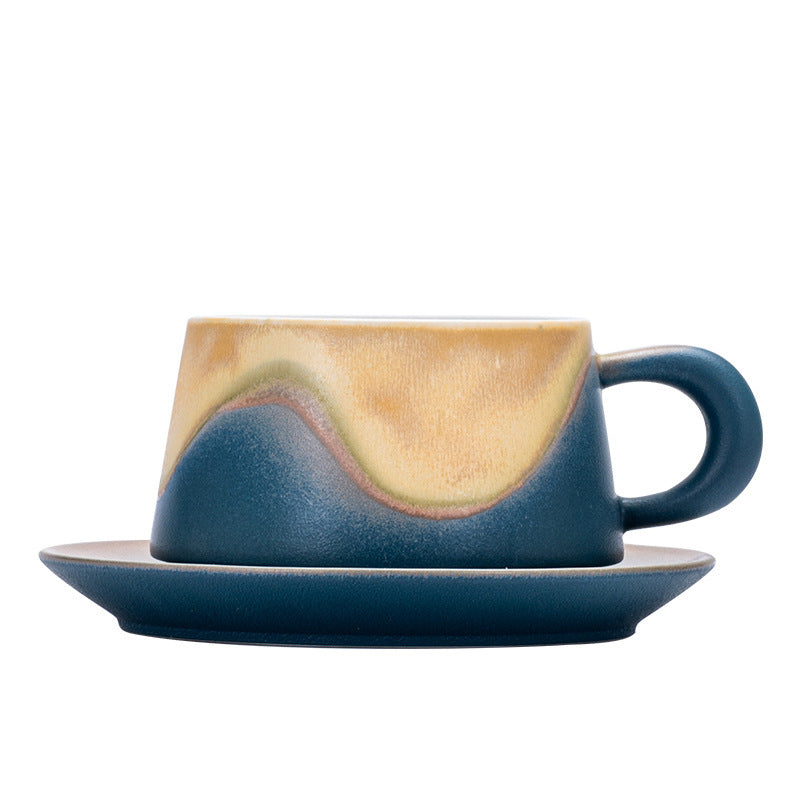 Close view of the blue ceramic cup wave-shaped glaze transition, handle and saucer