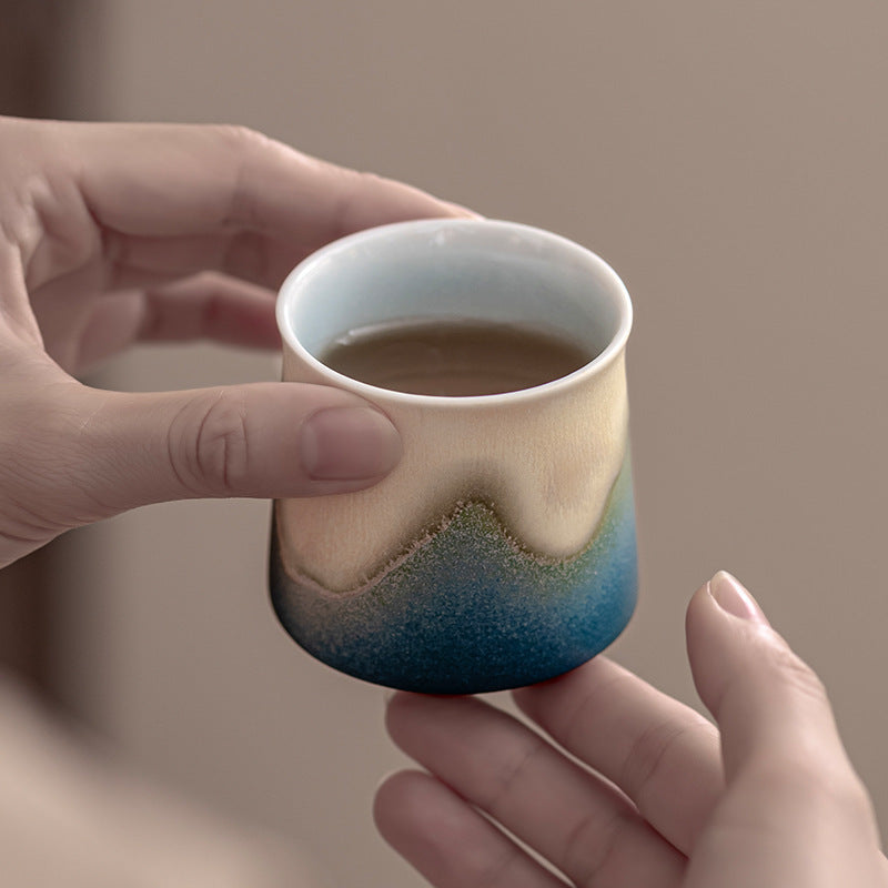 Blue mountain glaze tea cup held in hands