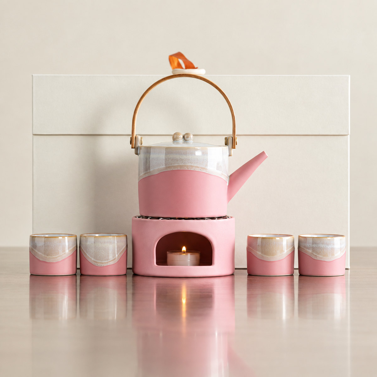 Pink arched-handle ceramic teapot, matching warmer and four cups with ivory gift box