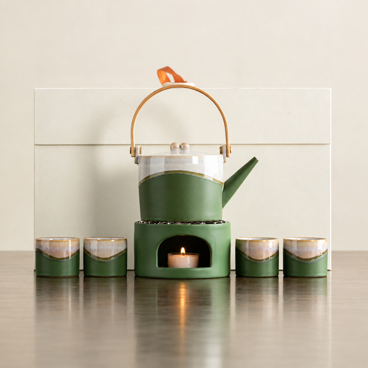 Green arched-handle ceramic teapot, matching warmer and four cups with ivory gift box
