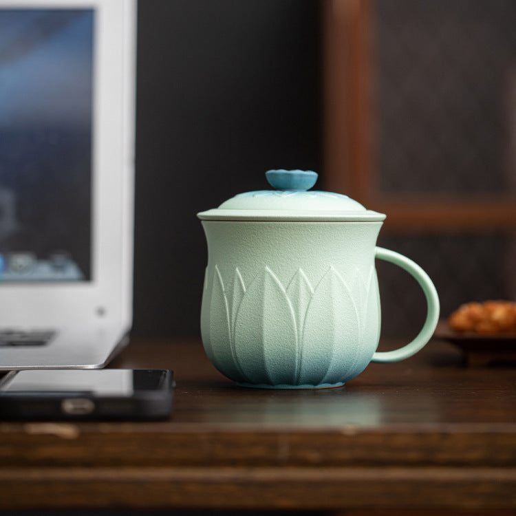 Mint lotus tea mug with lid on a desk