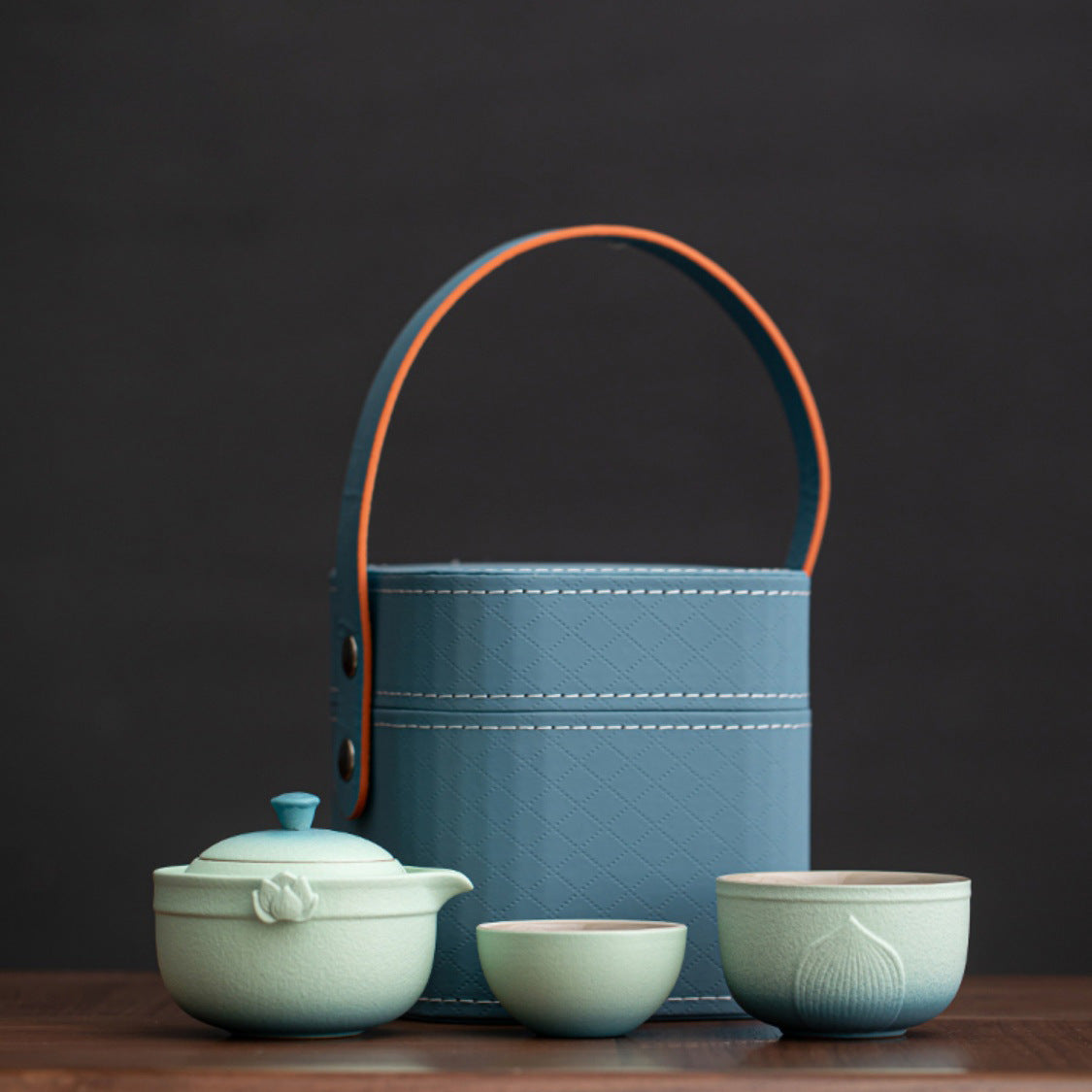 Celadon lotus travel tea set with one lidded pot two cups and blue carry case