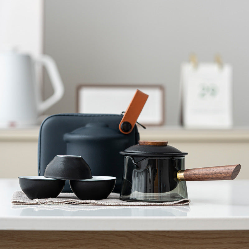Glass tea brewer and three ceramic cups in black / side handle configuration