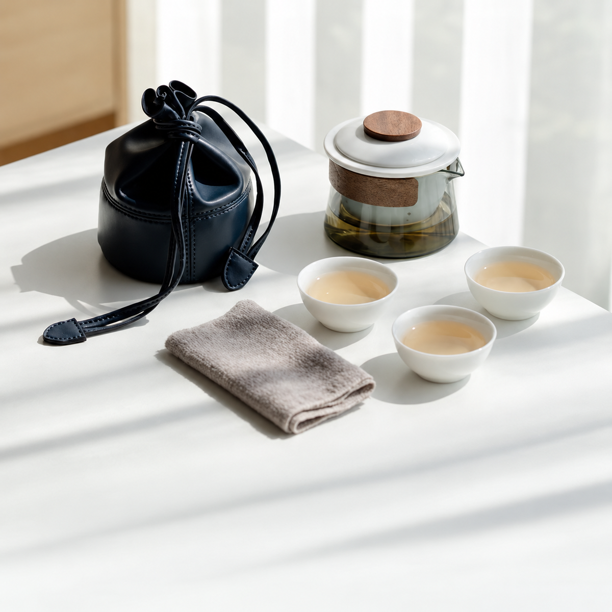 Glass tea brewer and three ceramic cups in white / drawstring pouch configuration