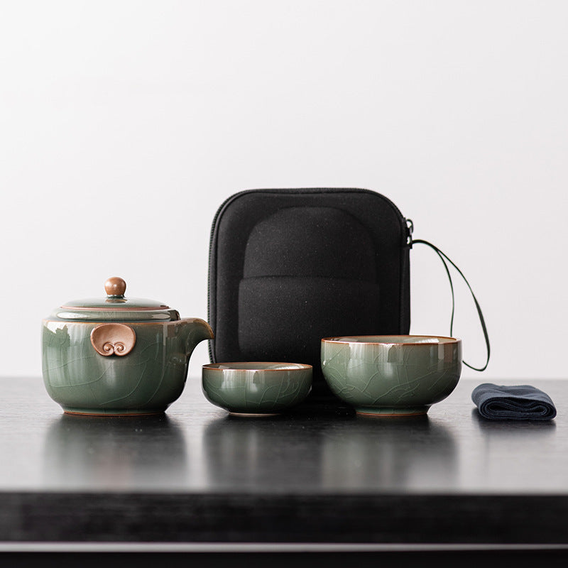 Jade green ceramic travel teapot with two nesting cups, cloth and black zip case