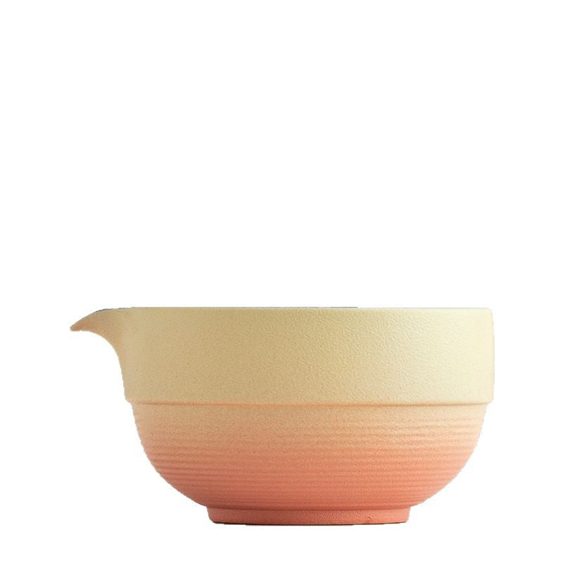 Close-up of the yellow and orange bowl profile, ribbed lower body and pouring spout