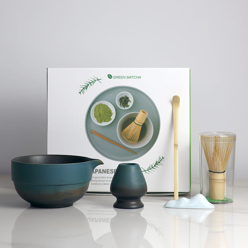 Blue and Black - 5 Pieces matcha set showing the bowl, holder, whisk, scoop and actual retail box, with a ceramic utensil rest