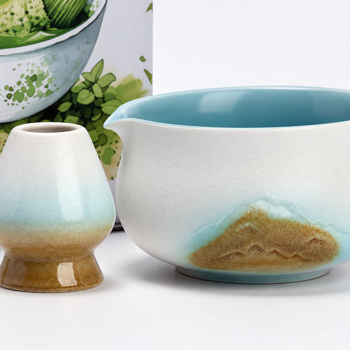 Close view of the white mountain-pattern matcha bowl, pouring lip, blue interior and matching whisk holder
