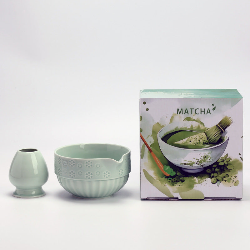 Celadon embossed-flower matcha bowl and whisk holder with the illustrated MATCHA carton