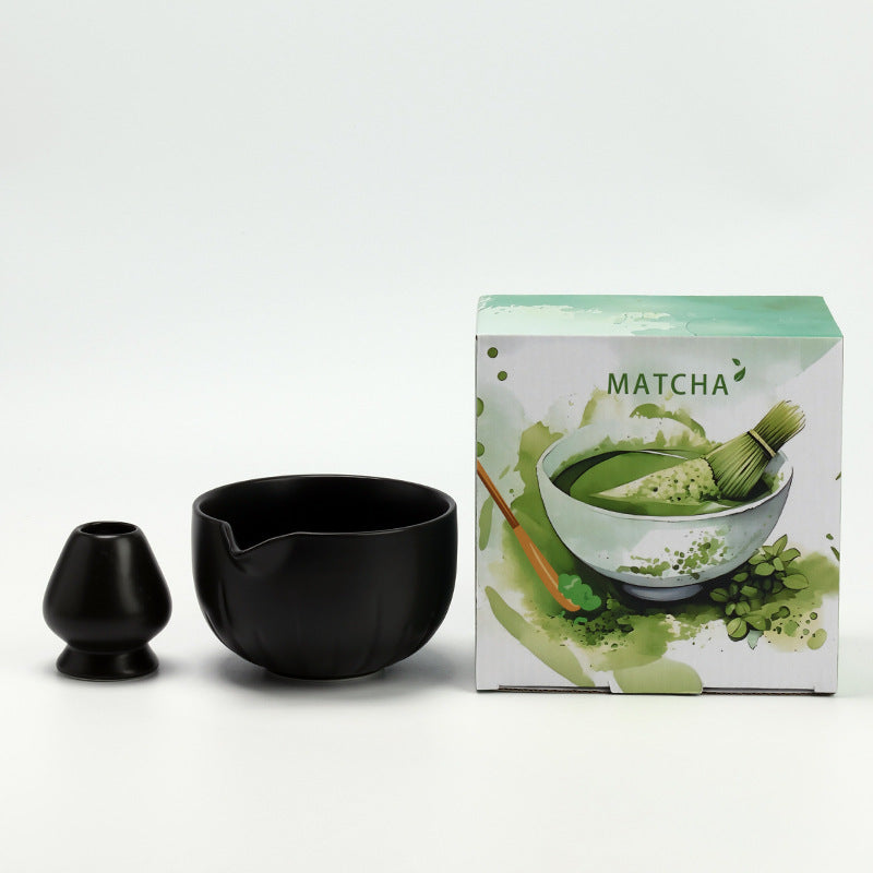 Petal Bowl - Matte Black ceramic bowl and coordinating whisk holder beside the associated MATCHA carton