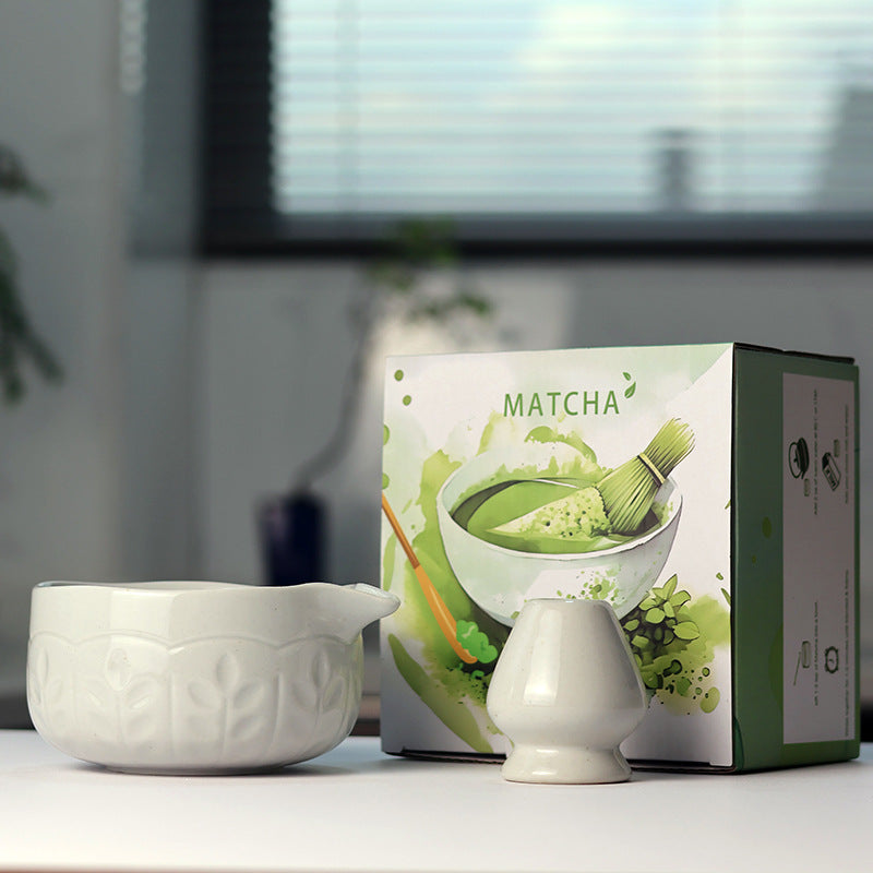 Leaf Relief - Ice White ceramic bowl and coordinating whisk holder beside the associated MATCHA carton