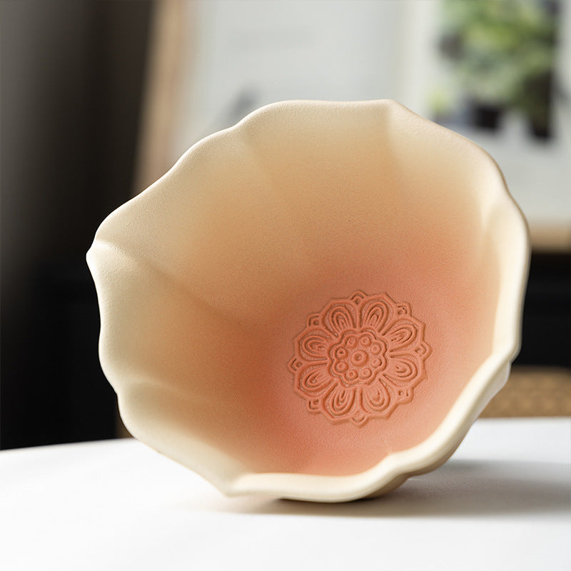 Close view of the scalloped rim and embossed floral motif inside the gradient matcha bowl
