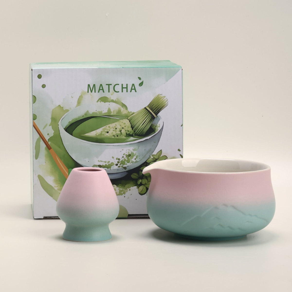 Pink and mint mountain-relief matcha bowl and ceramic whisk holder with the included MATCHA box